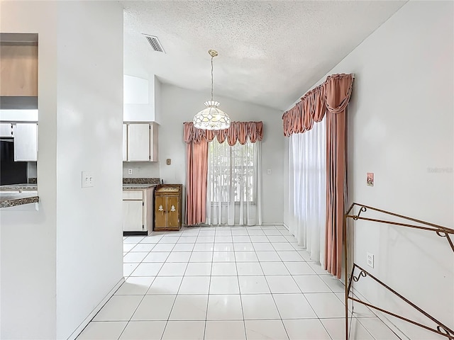 11216 Longbrooke Dr, Riverview, FL 33579 - unfurnished dining area featuring lofted ceiling, light tile patterned flooring, and a textured ceiling