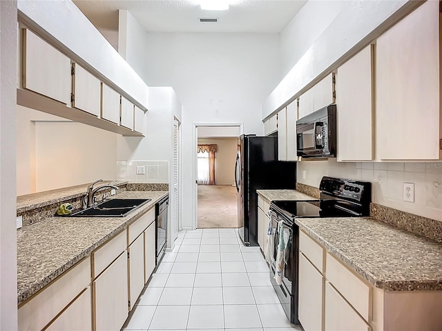 11216 Longbrooke Dr, Riverview, FL 33579 - kitchen with black appliances, a sink, high vaulted ceiling, and light tile patterned floors