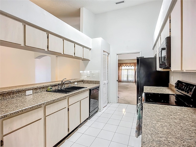 11216 Longbrooke Dr, Riverview, FL 33579 - kitchen with high vaulted ceiling, black appliances, a sink, light tile patterned floors, and light carpet