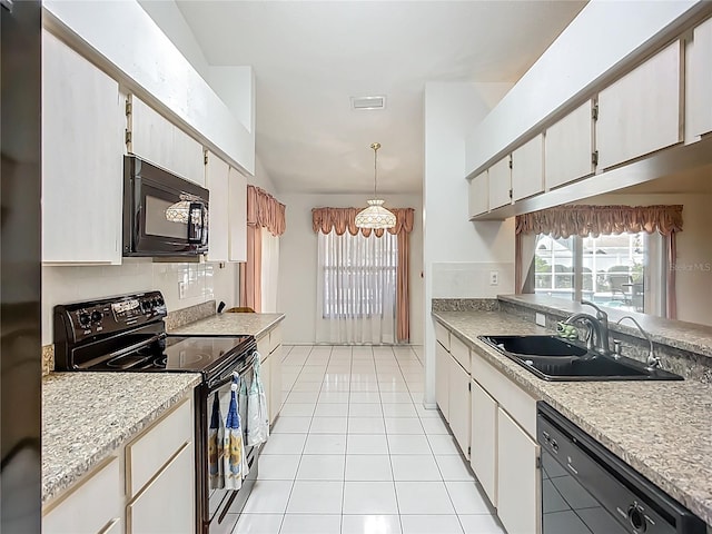 11216 Longbrooke Dr, Riverview, FL 33579 - kitchen featuring black appliances, a sink, light countertops, light tile patterned flooring, and white cabinets