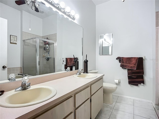 11216 Longbrooke Dr, Riverview, FL 33579 - bathroom with a shower stall, tile patterned flooring, a ceiling fan, double vanity, and toilet
