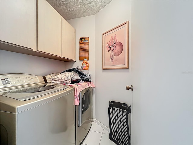 11216 Longbrooke Dr, Riverview, FL 33579 - washroom with cabinet space, washer and dryer, a textured ceiling, and light tile patterned flooring
