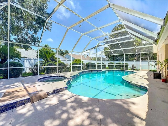 11216 Longbrooke Dr, Riverview, FL 33579 - view of swimming pool featuring a fenced backyard, a patio area, a pool with connected hot tub, and a lanai