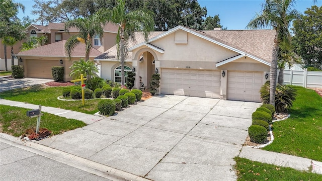 11216 Longbrooke Dr, Riverview, FL 33579 - view of front of house featuring stucco siding, driveway, an attached garage, and roof with shingles