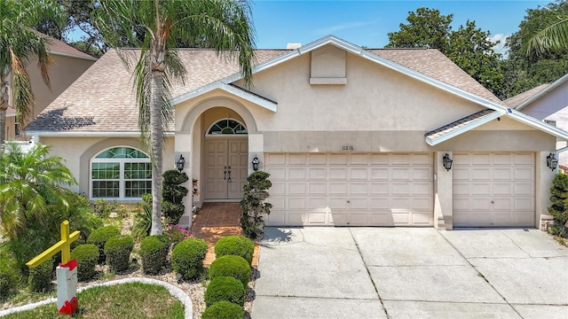 11216 Longbrooke Dr, Riverview, FL 33579 - view of front facade with stucco siding, roof with shingles, concrete driveway, and an attached garage