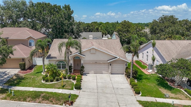 11216 Longbrooke Dr, Riverview, FL 33579 - view of front of property featuring a garage, driveway, stucco siding, a shingled roof, and central AC unit