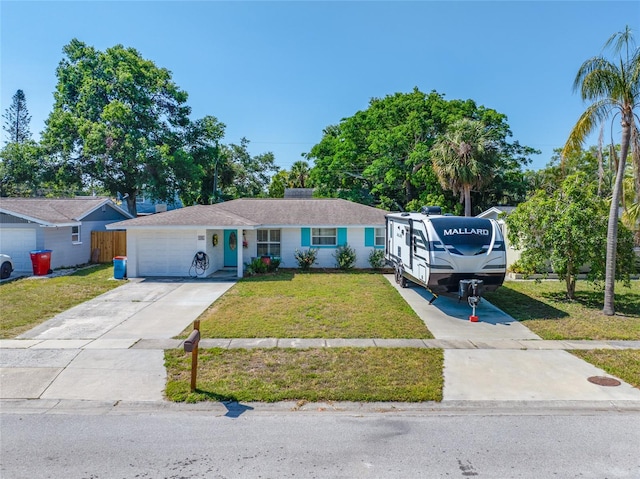 ranch-style home with an attached garage, a front lawn, and concrete driveway