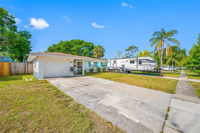 ranch-style house with concrete driveway, a front lawn, fence, and a garage