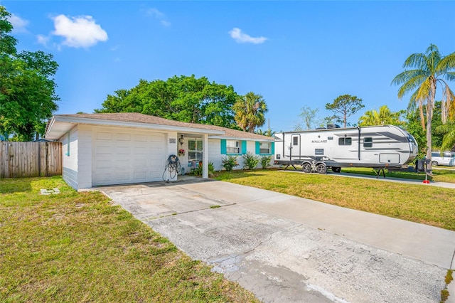 ranch-style house with concrete driveway, an attached garage, fence, and a front yard