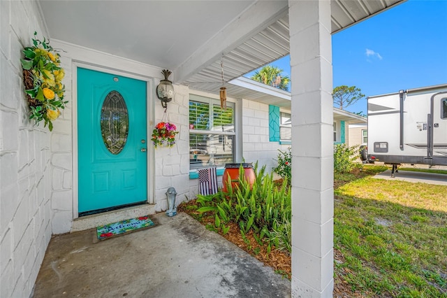 doorway to property featuring concrete block siding