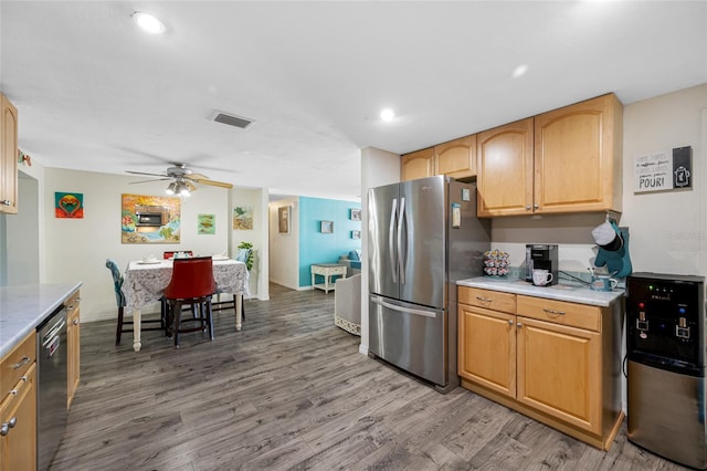 kitchen with a ceiling fan, light countertops, light wood-style flooring, appliances with stainless steel finishes, and visible vents