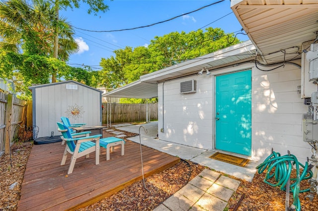 wooden terrace with an outdoor structure, a shed, and a fenced backyard