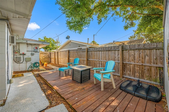 wooden terrace with a fenced backyard