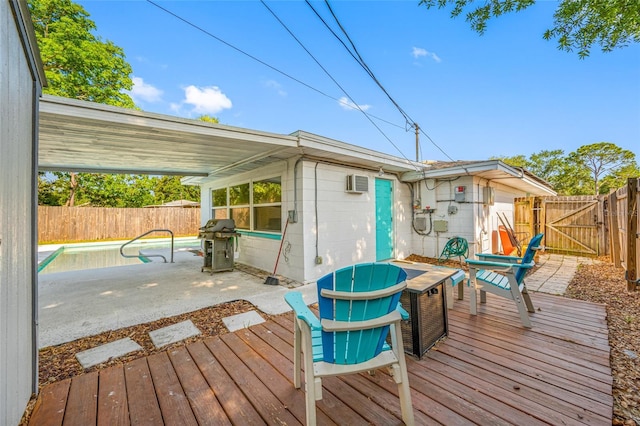 wooden terrace with a fenced in pool, a gate, area for grilling, a fenced backyard, and a wall mounted AC