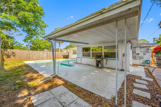 view of patio / terrace with a fenced in pool, area for grilling, and a fenced backyard