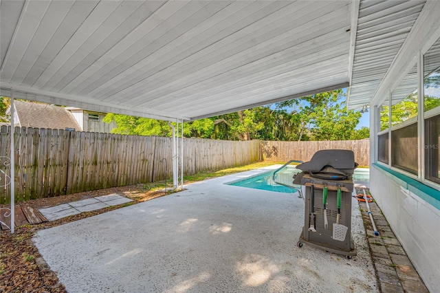 view of swimming pool with a patio area, a fenced backyard, a fenced in pool, and a grill