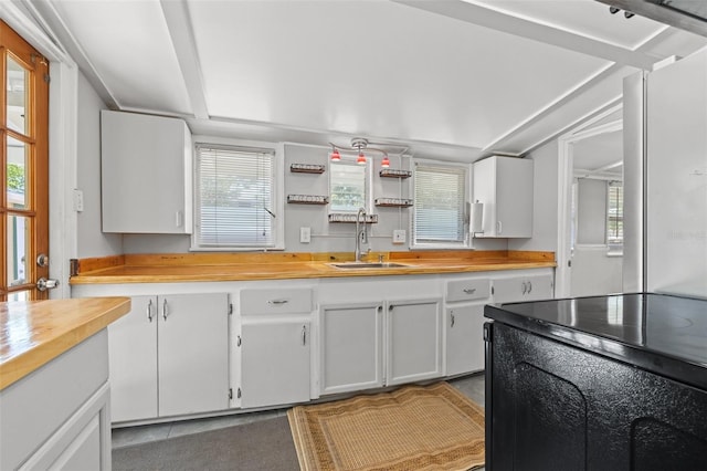 2450 3rd Ave N, Saint Petersburg, FL 33713 - kitchen featuring white cabinets, healthy amount of natural light, tile patterned flooring, and butcher block countertops