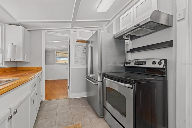 2450 3rd Ave N, Saint Petersburg, FL 33713 - kitchen featuring stainless steel electric range oven, extractor fan, white cabinets, and light tile patterned floors