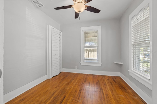2450 3rd Ave N, Saint Petersburg, FL 33713 - unfurnished bedroom with multiple windows, wood-type flooring, and a ceiling fan