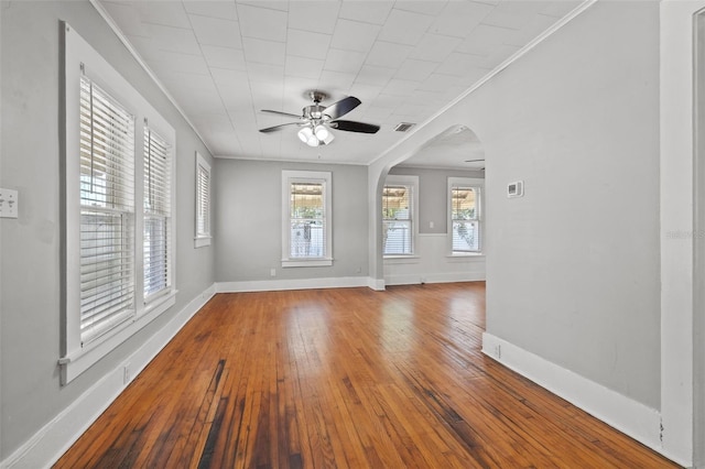 2450 3rd Ave N, Saint Petersburg, FL 33713 - spare room with arched walkways, a ceiling fan, crown molding, and hardwood / wood-style floors