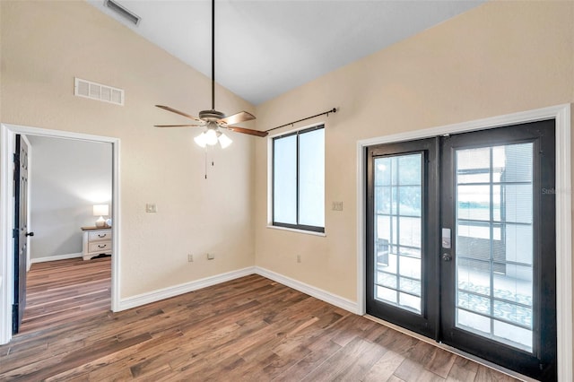 interior space with lofted ceiling, plenty of natural light, wood finished floors, visible vents, and french doors