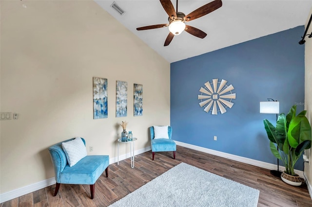 living area featuring vaulted ceiling, wood finished floors, ceiling fan, baseboards, and visible vents