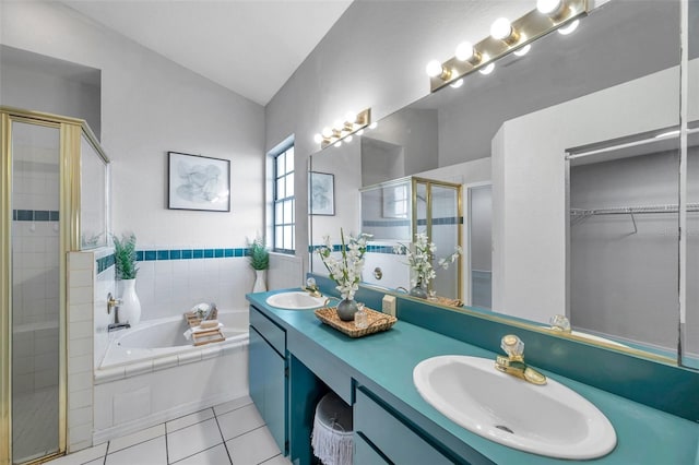full bath featuring a bath, a sink, double vanity, tile patterned flooring, and a shower stall