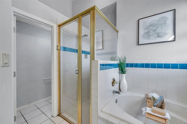 full bath with tile patterned floors, a garden tub, and a shower stall
