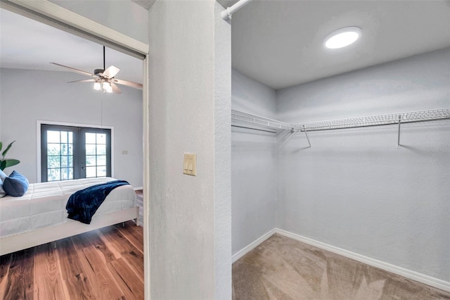 walk in closet with ceiling fan and lofted ceiling