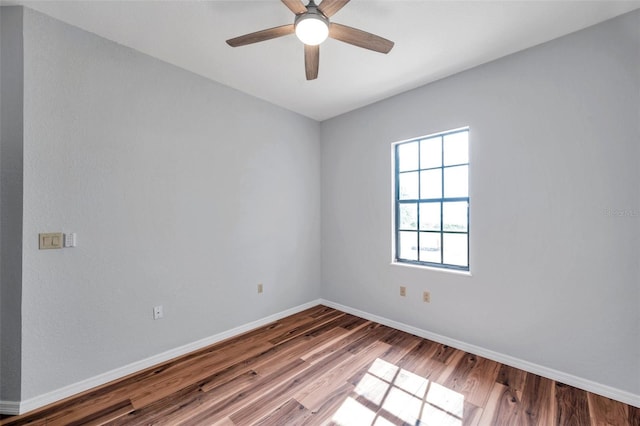 empty room featuring baseboards, a ceiling fan, and wood finished floors