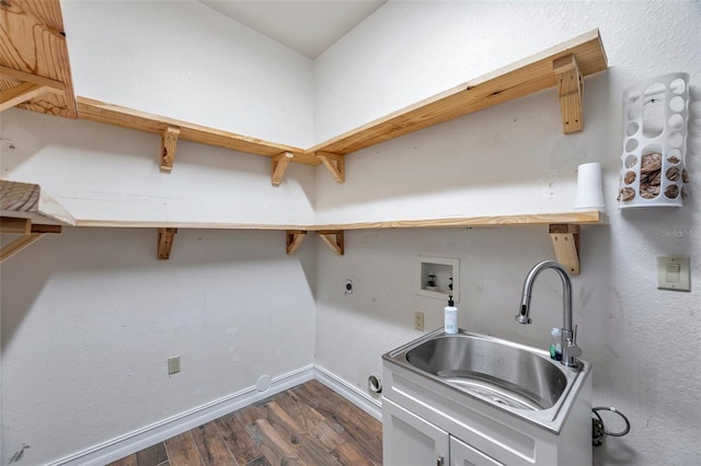 clothes washing area featuring dark wood finished floors, hookup for an electric dryer, a sink, cabinet space, and washer hookup