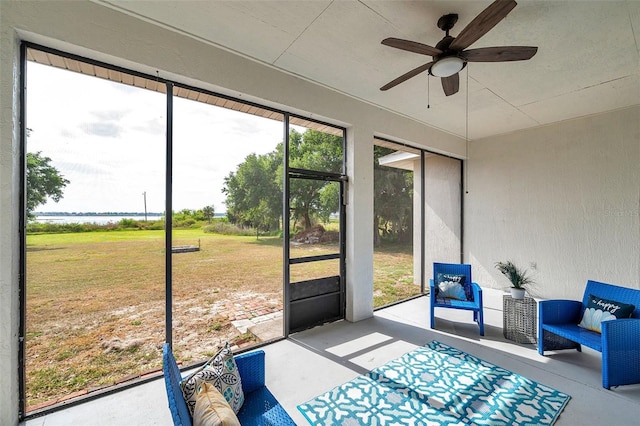 sunroom / solarium with ceiling fan and outdoor lounge area