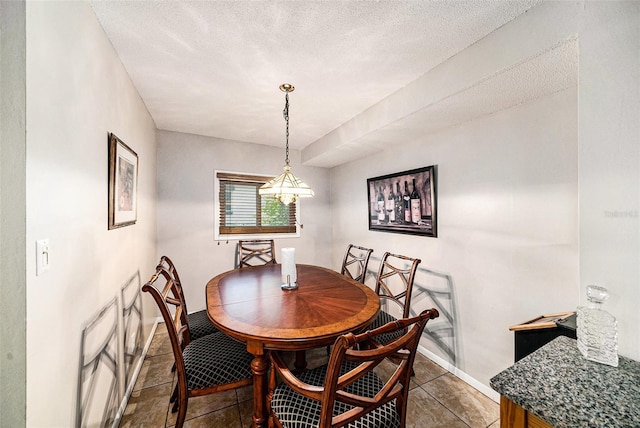 1399 Leeward Ave, Spring Hill, FL 34606 - dining space featuring baseboards, tile patterned flooring, a chandelier, and a textured ceiling