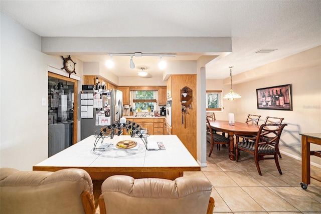 1399 Leeward Ave, Spring Hill, FL 34606 - dining area with track lighting, visible vents, and light tile patterned floors