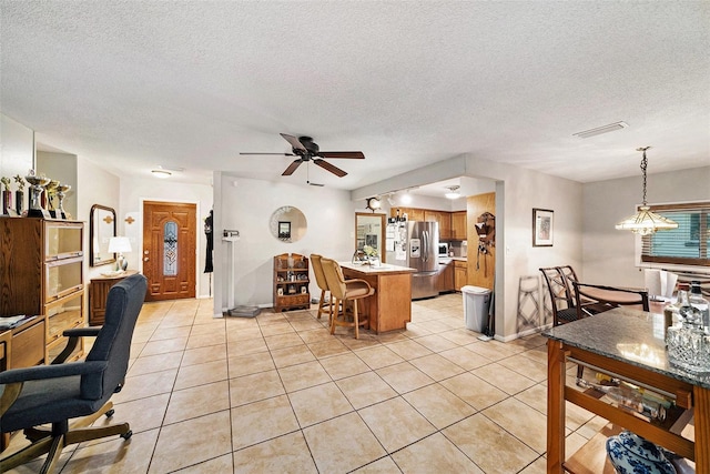 1399 Leeward Ave, Spring Hill, FL 34606 - interior space with visible vents, light tile patterned flooring, baseboards, a textured ceiling, and ceiling fan with notable chandelier