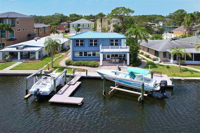 5449 Manatee Point Dr, New Port Richey, FL 34652 - back of house featuring a residential view, boat lift, and a water view