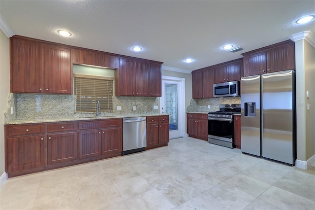 5449 Manatee Point Dr, New Port Richey, FL 34652 - kitchen with appliances with stainless steel finishes, tasteful backsplash, crown molding, light stone countertops, and recessed lighting