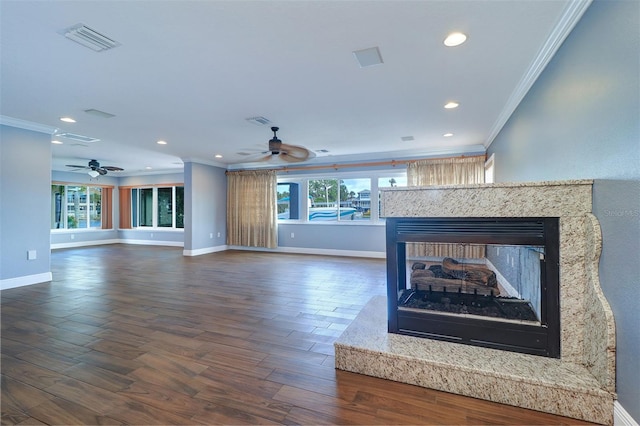 5449 Manatee Point Dr, New Port Richey, FL 34652 - unfurnished living room featuring crown molding, a ceiling fan, plenty of natural light, dark wood-style flooring, and recessed lighting