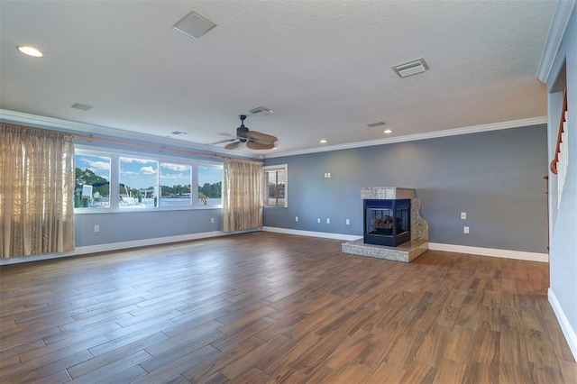 5449 Manatee Point Dr, New Port Richey, FL 34652 - unfurnished living room featuring crown molding, a fireplace, dark wood finished floors, a ceiling fan, and recessed lighting