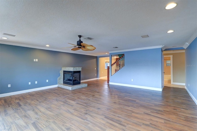 5449 Manatee Point Dr, New Port Richey, FL 34652 - unfurnished living room with crown molding, stairs, recessed lighting, ceiling fan, and a textured ceiling