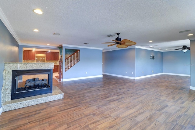 5449 Manatee Point Dr, New Port Richey, FL 34652 - unfurnished living room with a ceiling fan, crown molding, a textured ceiling, stairway, and recessed lighting