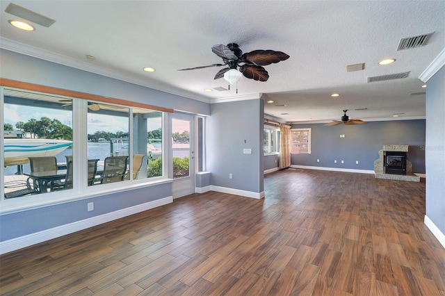 5449 Manatee Point Dr, New Port Richey, FL 34652 - unfurnished living room with ceiling fan, crown molding, dark wood-style floors, recessed lighting, and a glass covered fireplace