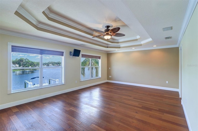5449 Manatee Point Dr, New Port Richey, FL 34652 - unfurnished room with a tray ceiling, ceiling fan, hardwood / wood-style flooring, and ornamental molding