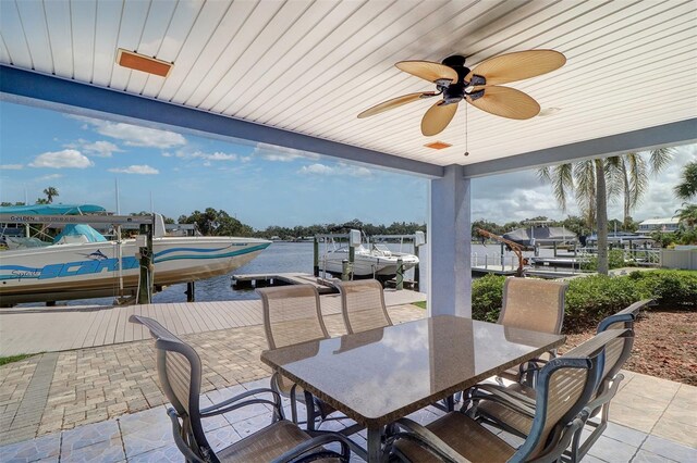 5449 Manatee Point Dr, New Port Richey, FL 34652 - view of patio featuring outdoor dining space, ceiling fan, boat lift, and a dock