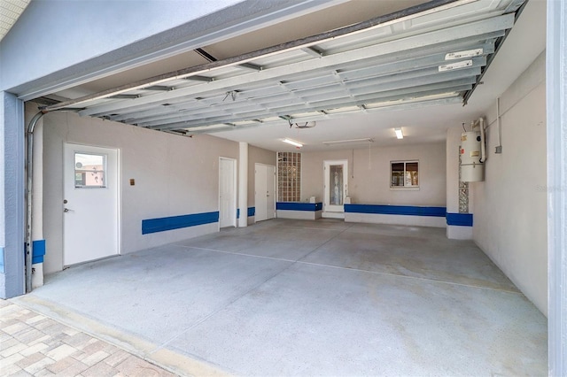 5449 Manatee Point Dr, New Port Richey, FL 34652 - garage featuring a central vacuum unit and a garage door opener