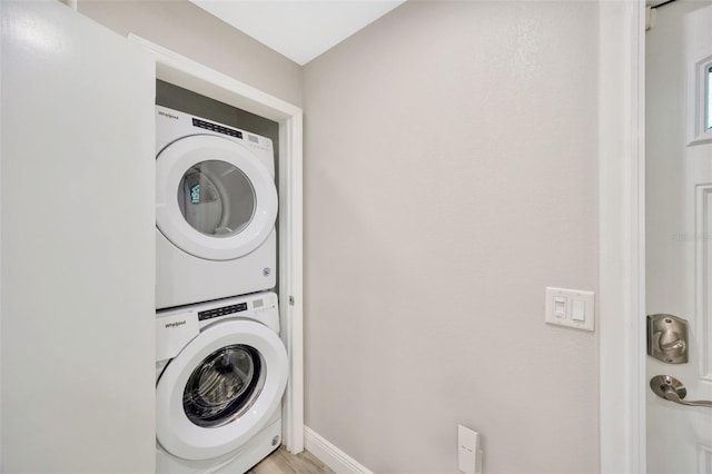 1155 Withlacoochee St, Safety Harbor, FL 34695 - clothes washing area featuring stacked washer / dryer, laundry area, and baseboards