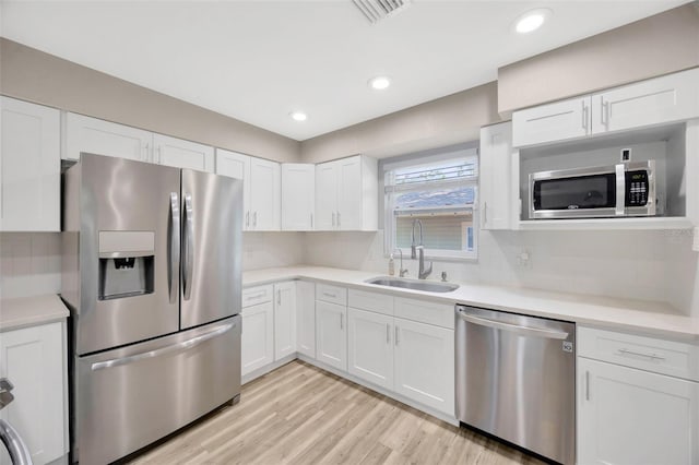 1155 Withlacoochee St, Safety Harbor, FL 34695 - kitchen featuring a sink, white cabinets, stainless steel appliances, and visible vents