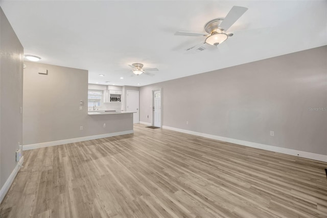 1155 Withlacoochee St, Safety Harbor, FL 34695 - unfurnished living room with recessed lighting, ceiling fan, visible vents, light wood-style flooring, and baseboards