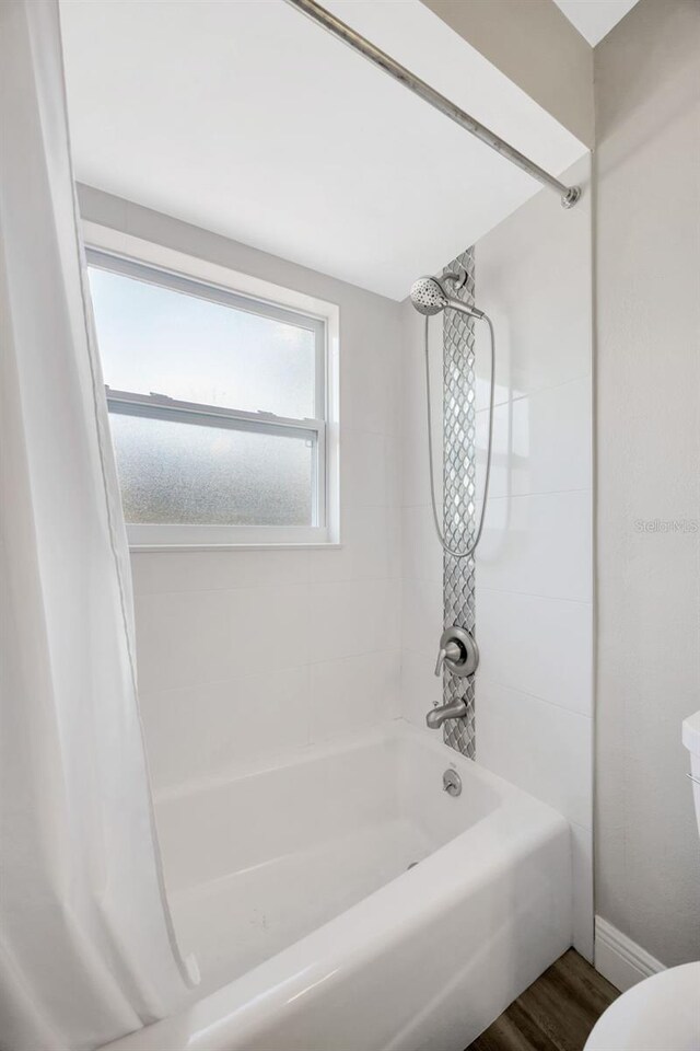 1155 Withlacoochee St, Safety Harbor, FL 34695 - bathroom with shower / bath combo, wood finished floors, and toilet