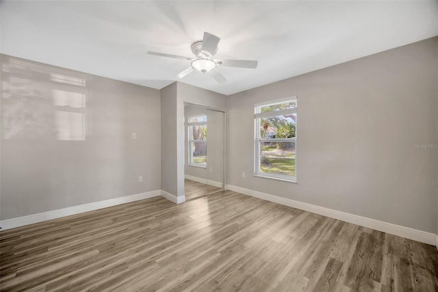 1155 Withlacoochee St, Safety Harbor, FL 34695 - unfurnished room featuring a ceiling fan, light wood-style flooring, and baseboards